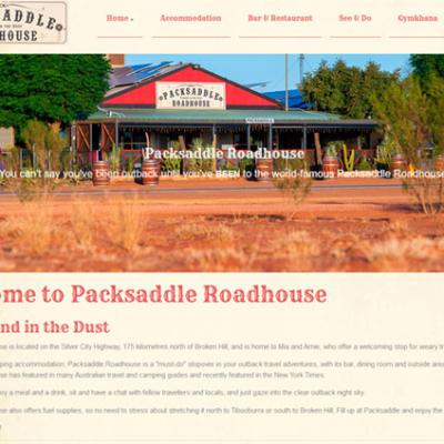 Website design for Packsaddle Roadhouse featuring a photo of the outback building and vintage-style logo